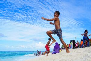 Locals playing on the beach in Maldives